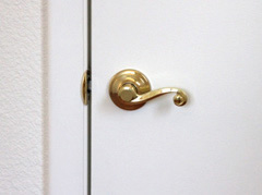 Lever style door handle on a smooth finish door