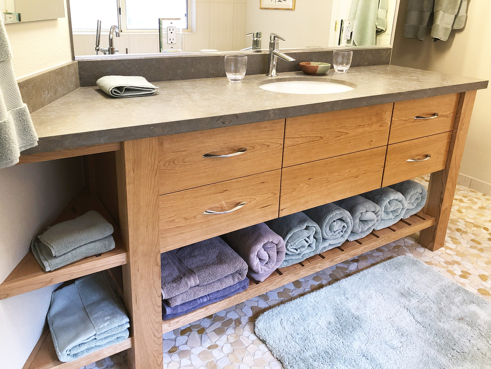 Bathroom remodel in Sedona AZ with custom cabinetry, limestone counters and new mirror and tile floors