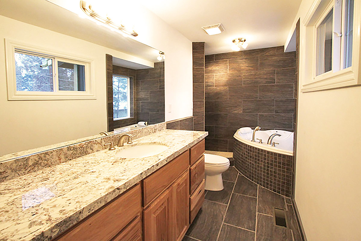 New Master Bathroom by Highwood Construction of Flagstaff Arizona, including hickory cabinets, granite countertops, Italian ceramic tile and a whirlpool tub.