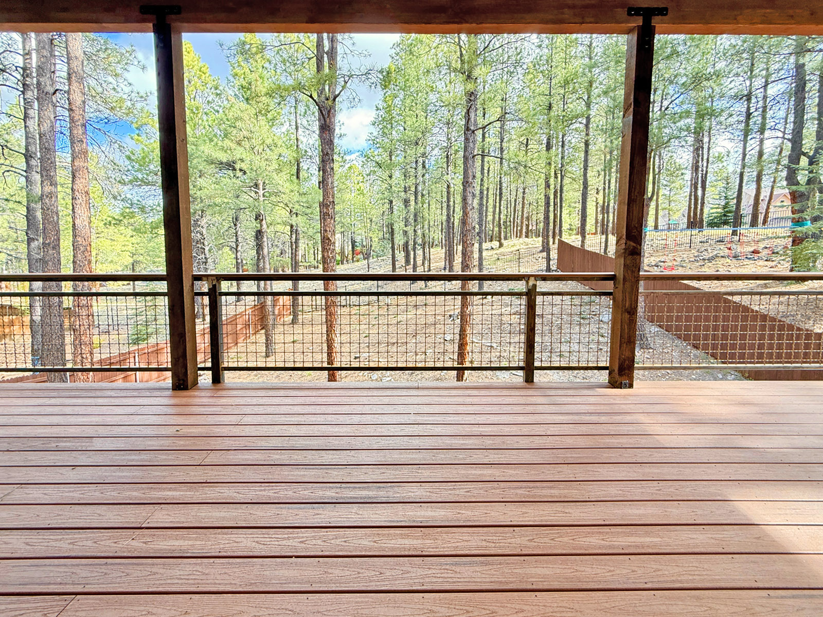 Trex deck in Flagstaff Arizona with a rusted metal railing overlooking the forest.