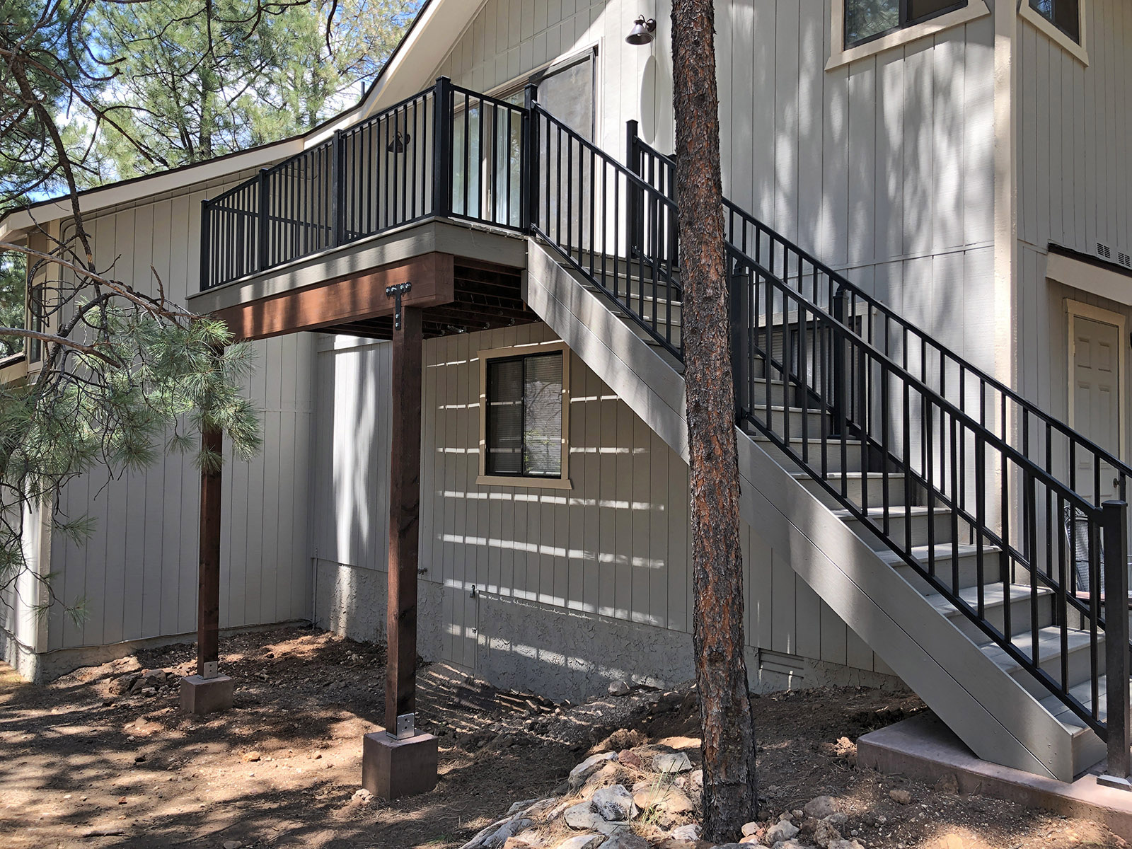 Grey Trex decking including Trex stairs.  Also pictured Trex Signature guardrail in black.