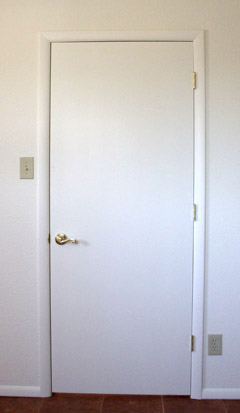 Smooth finish door installed by Highwood Construction