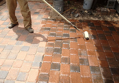 Applying "Arizona Seal" brand sealer to concrete pavers in Flagstaff AZ