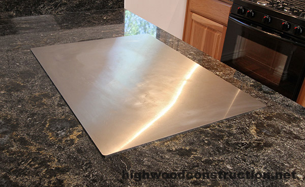 Teppanyaki grill installed in granite countertop in a home.